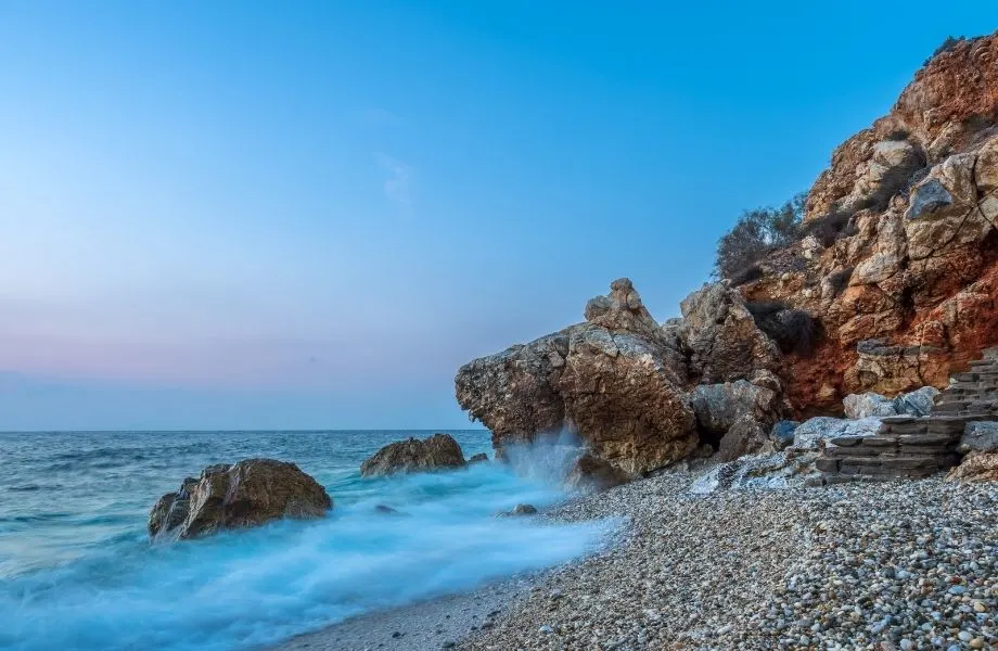 Paros' best beaches, water hitting the rocks along the coast of Piso Livadi Beach