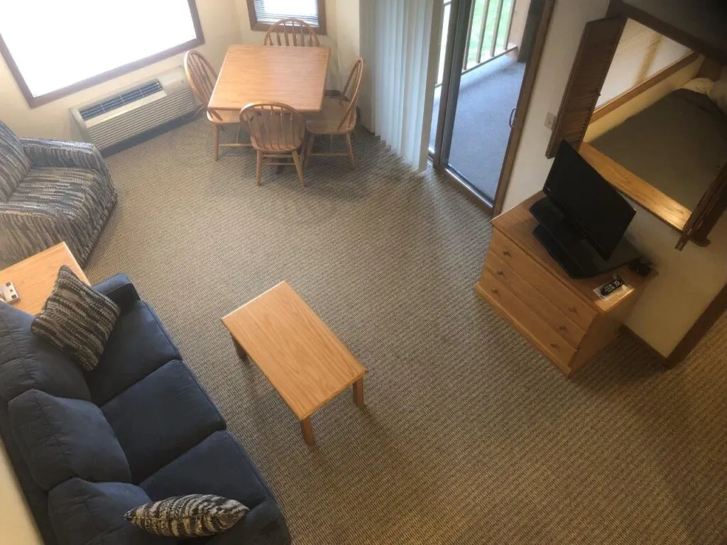 best places to stay in Door County for families, aerial view of room showing sofa, coffee table, tv and bed