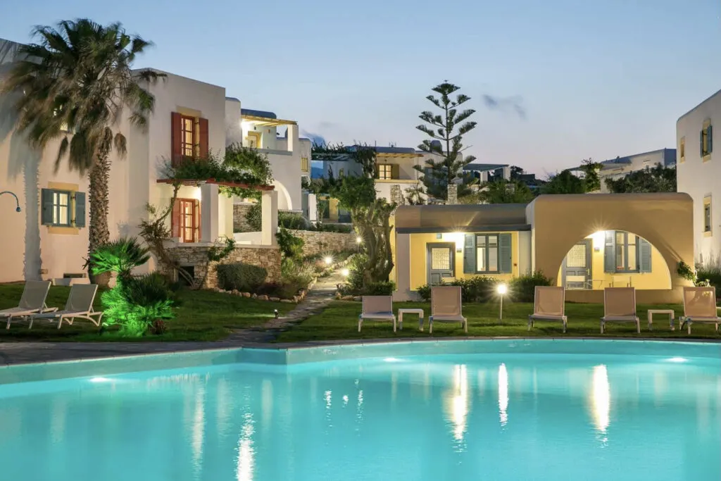 best hotels Greek Islands, exterior view of Acquamarina Resort lit up at night