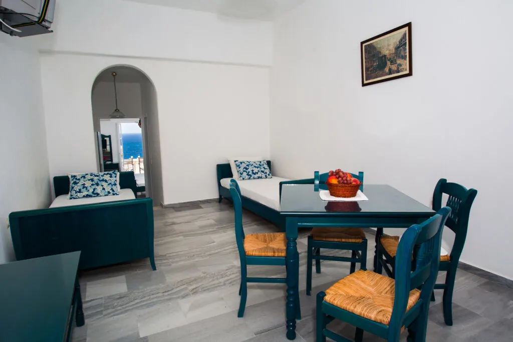 best places to stay in Paros, Arkas Inn room with two twin beds, table and four chairs, opens out onto beach