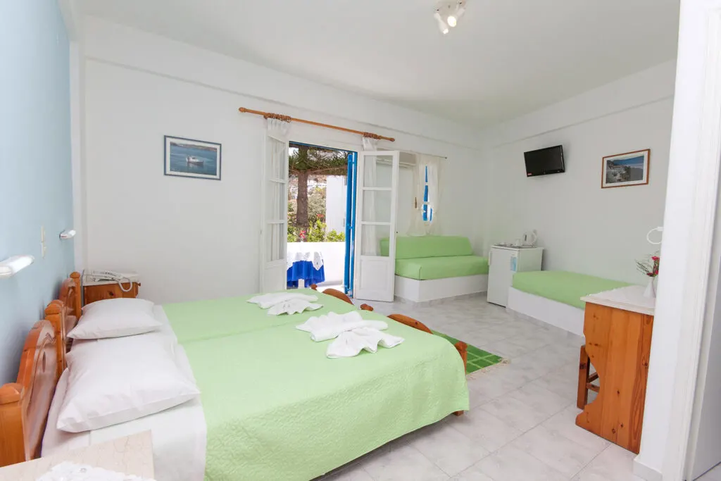 best Paros Greece resorts, room at Ayeri hotel with three beds, sofa, fridge and desk
