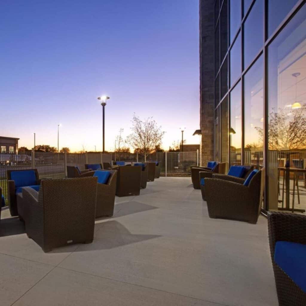 outdoor patio area with chairs and tables at sunset