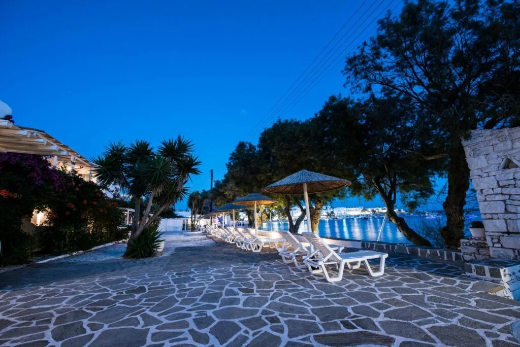 best accommodation for families in Paros, outdoor seating area overlooking marina at Ostria Studios & Apartments