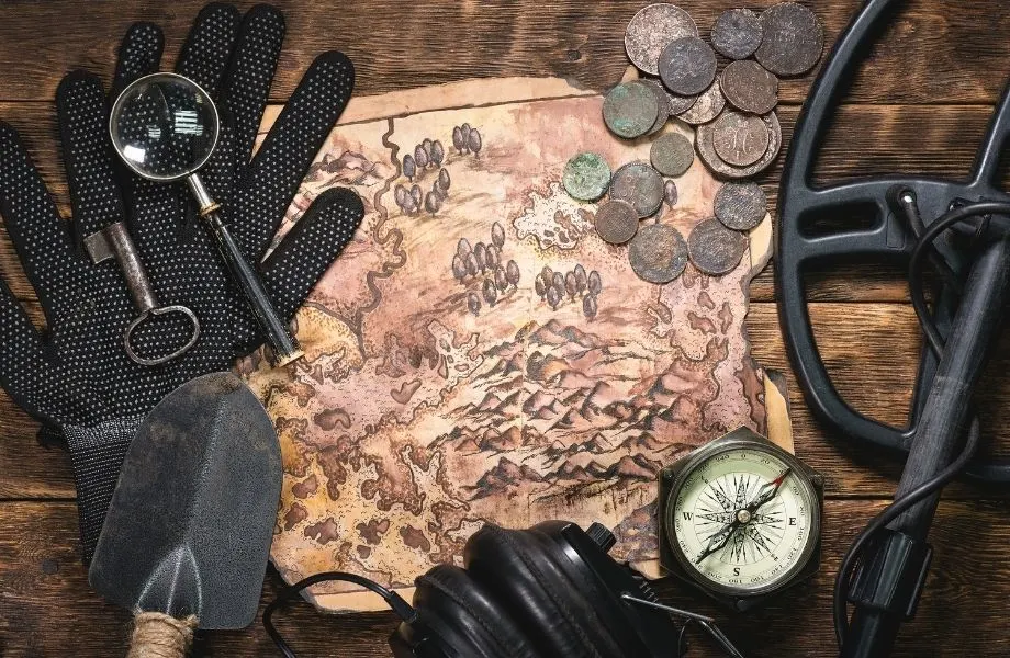 treasure map with old coins, compass, shovel and other tools; escape the room in Milwaukee has an Indiana Jones themed room