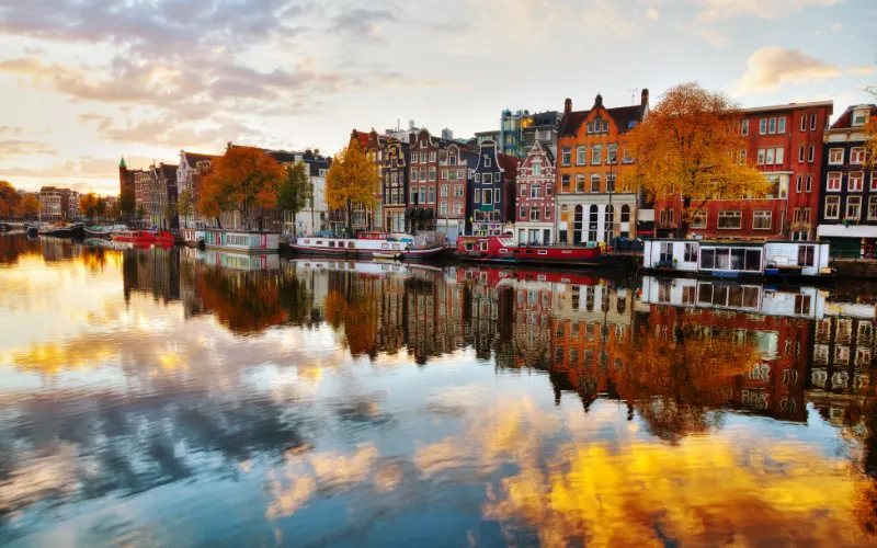 Amsterdam, city, a view of a city with colorful houses reflected on a body of water