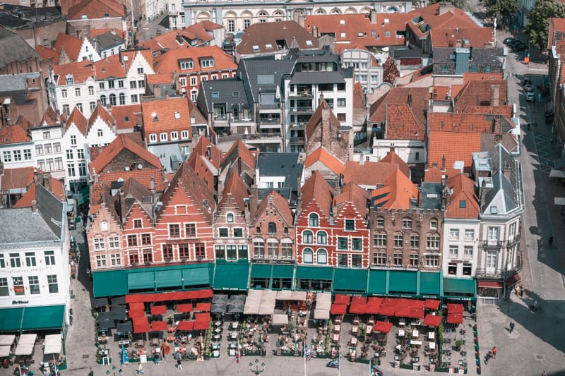 an aerial view of bruges with roofs and the belfry