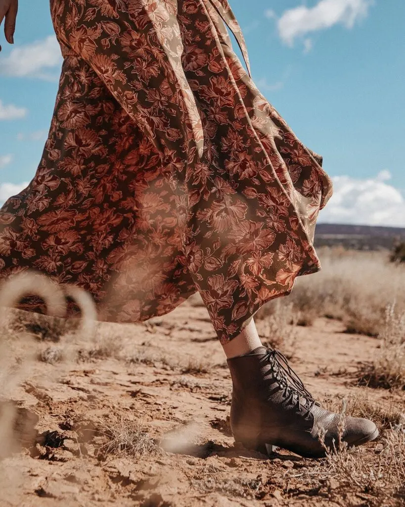 where to get ethical boots, person in flowy dress walking through desert in brown boots