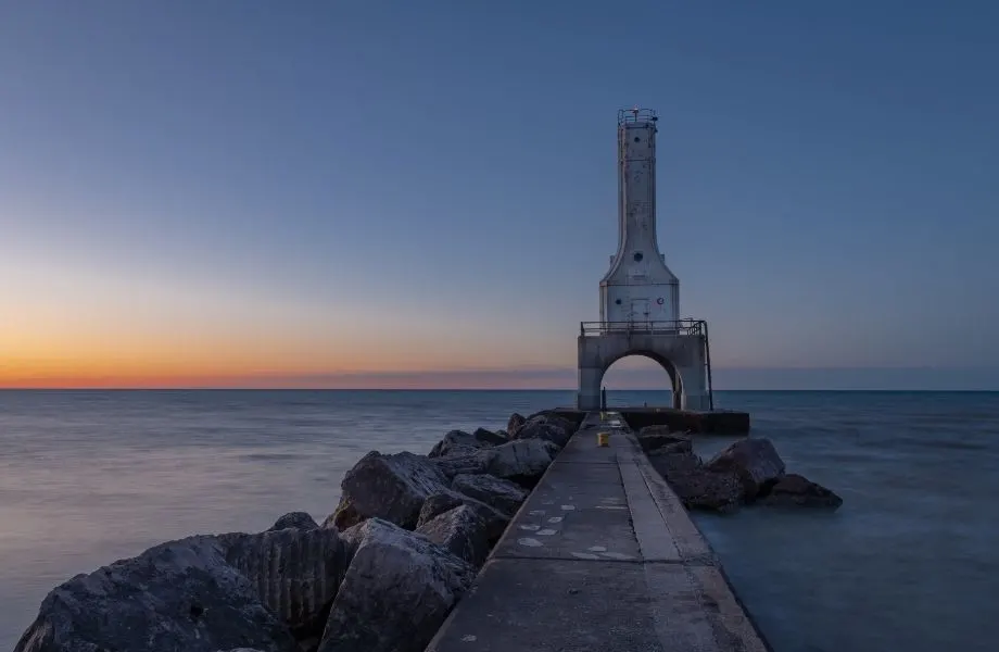 old lighthouses in Wisconsin, rocky pier out to Port Washington Station at sunset