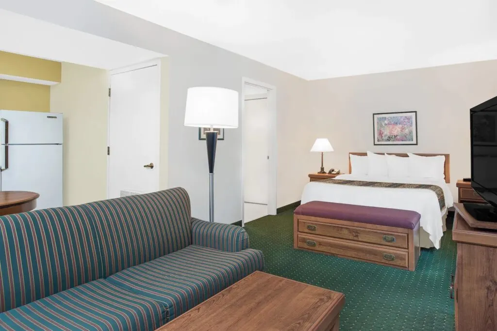 places to stay in green bay, large room with sofa, queen bed and kitchen at Hawthorn Suites Green Bay