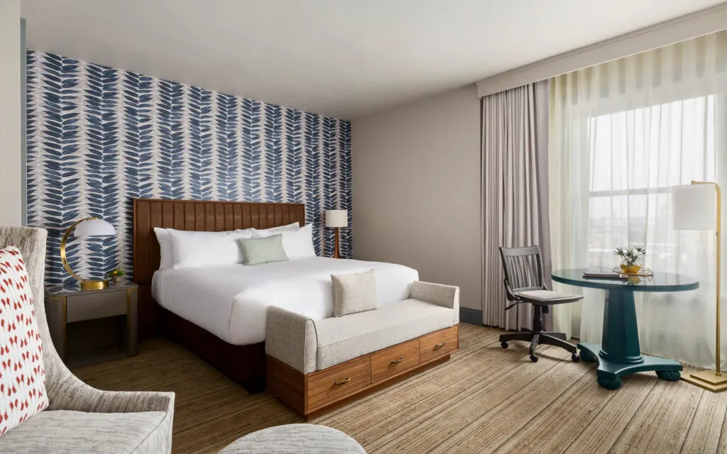 luxury hotels in green bay, room with table, comfy chair and bed at Hotel Northland