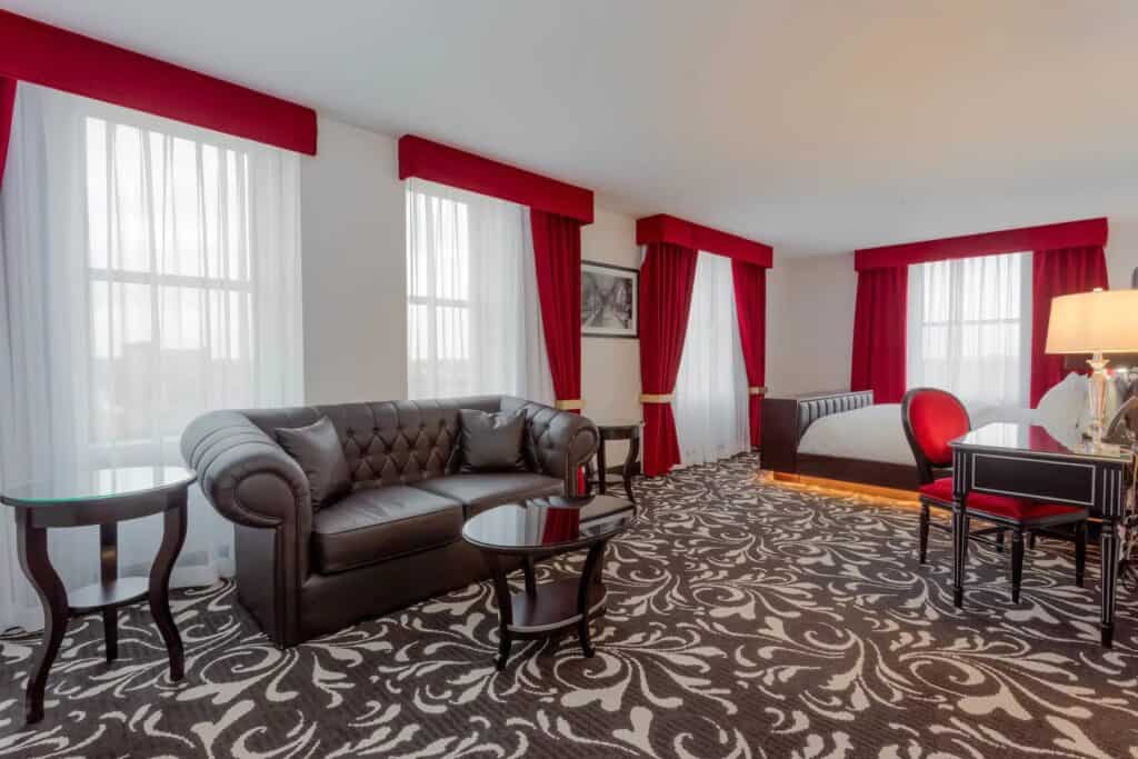 spooky getaways Wisconsin, large room with bed, desk and seating area at Hotel Retlaw