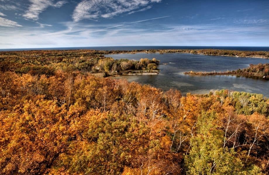 view of Potawatomi State Park filled with red and orange fall colors of the trees