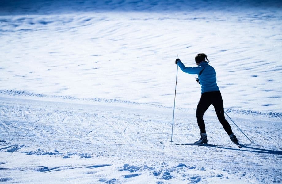 a person in a the snow climbing with a ski winter activities in Wisconsin, Cross Country Skiing around the best ski cabins in Wisconsin