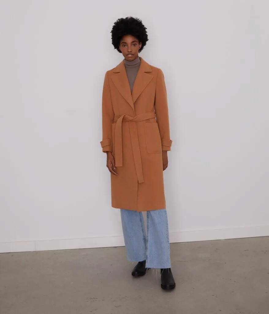 long sustainable winter jackets, woman wearing tan fabric trench coat