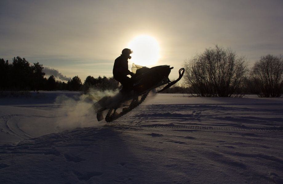 shawano county snowmobile trails, person riding a snowmobile at dusk