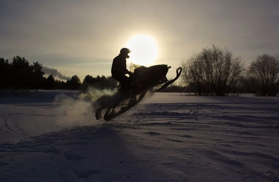 shawano county snowmobile trails, person riding a snowmobile at dusk