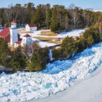 best places to visit Door County in winter, Sherwood Point Lighthouse surrounded by frozen lake