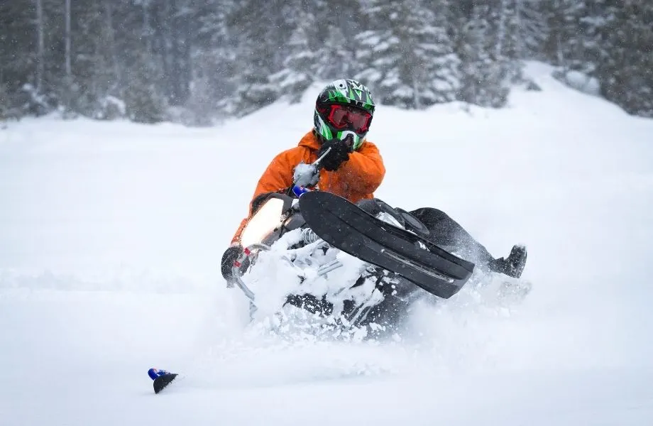 where to go snowmobiling in wisconsin, person riding snowmobile, snowmobile resorts in Wisconsin