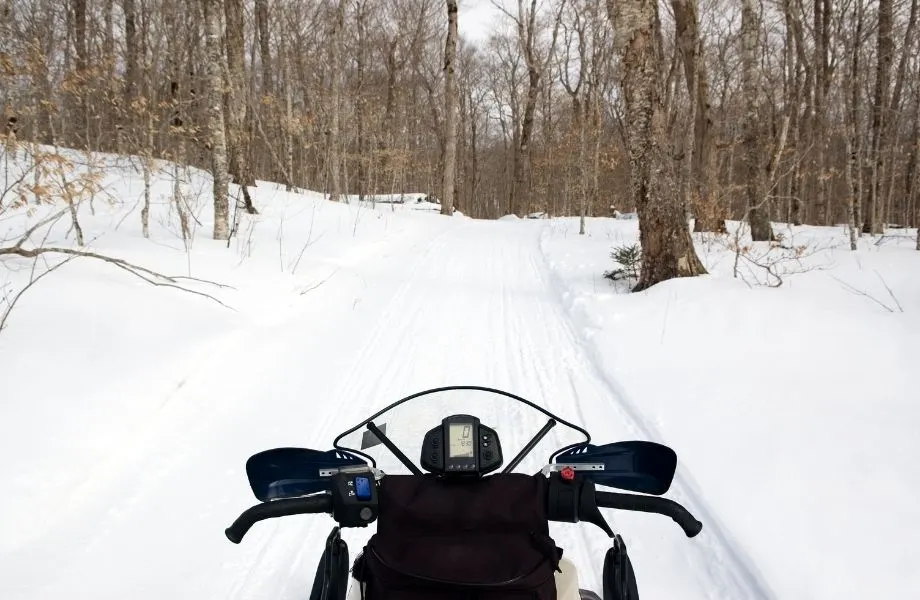 Boulder Junction Trails for snowmobiling, looking out a trail over a snowmobile