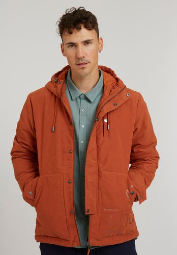 warmest sustainable winter coats, man in orange vegan jacket