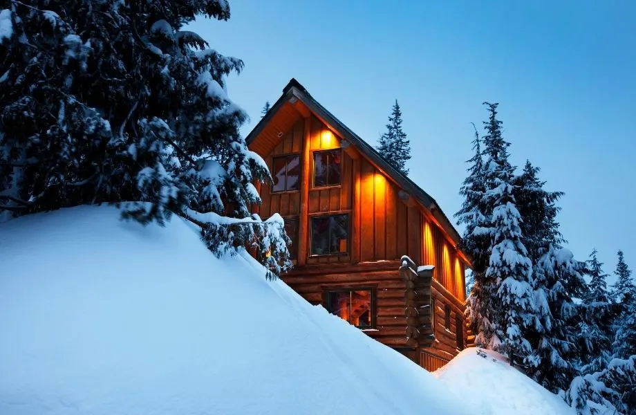 wood cabin in winter with snow on the foreground