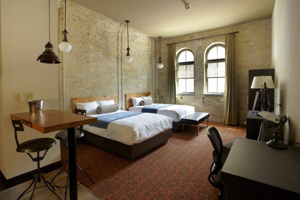 best romantic suites in milwaukee, two beds, desk, wardrobe, table and chairs in loft room