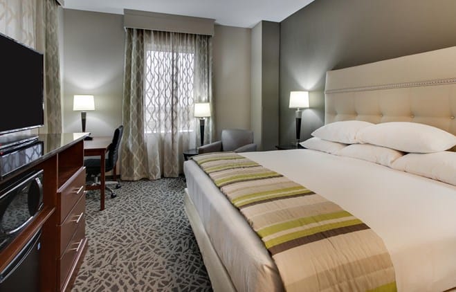 top milwaukee romantic hotels, hotel room with bed, sofa chair, desk and tv