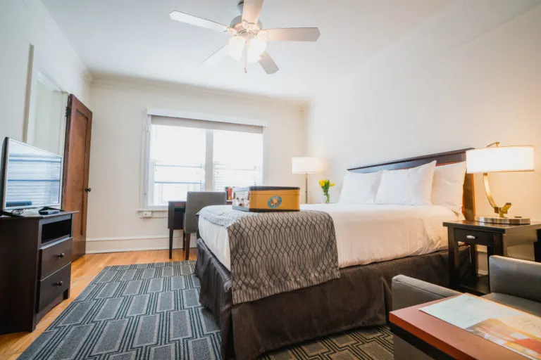 romantic hotels downtown milwaukee, hotel room with bed, desk, tv and sofa chairs