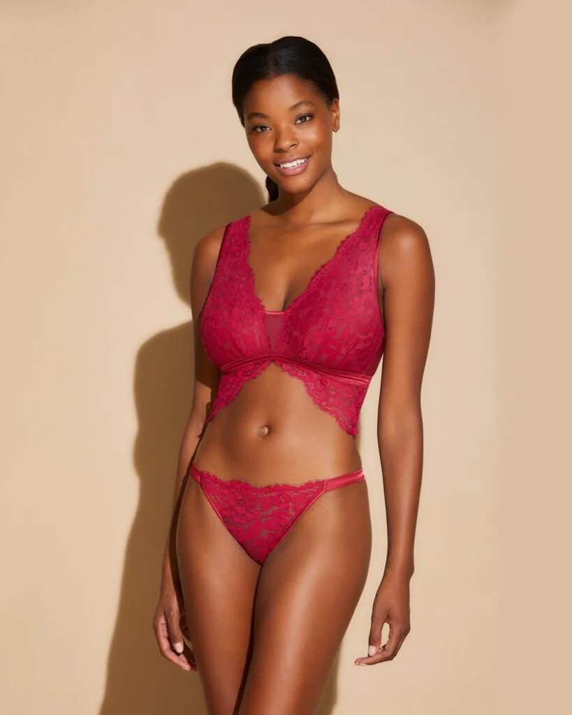 best sexy sustainable holiday gifts, black woman in matching red lace bra and underwear