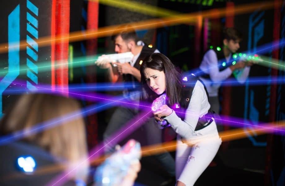 fun things to do in Milwaukee for couples, people pointing laser tag guns with lights going everywhere
