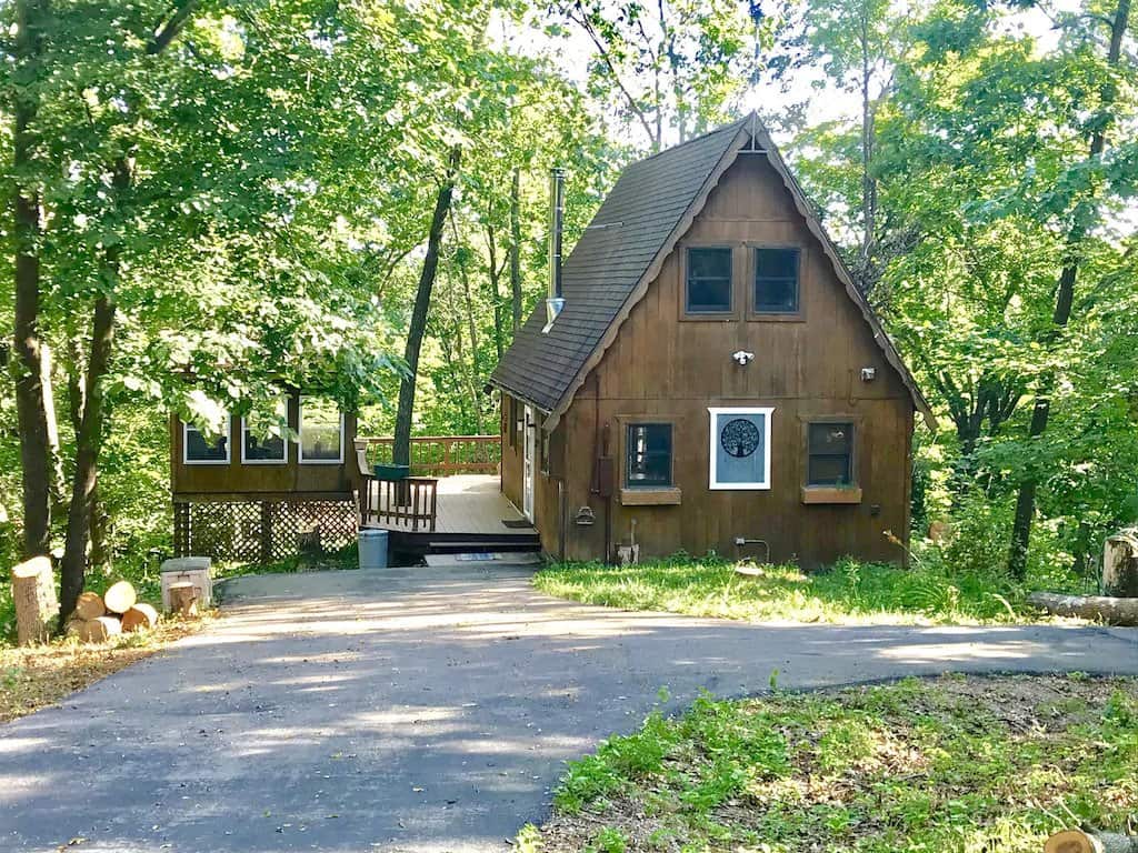 wisconsin romantic getaway cabins, exterior of secluded wooden cabin with large porch