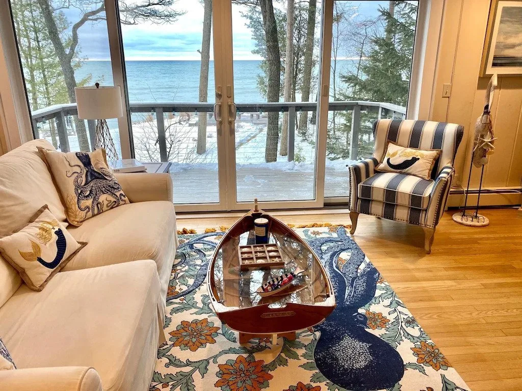 wisconsin cabin rentals for couples, view of beach from living room that is decorated with ocean themed decor