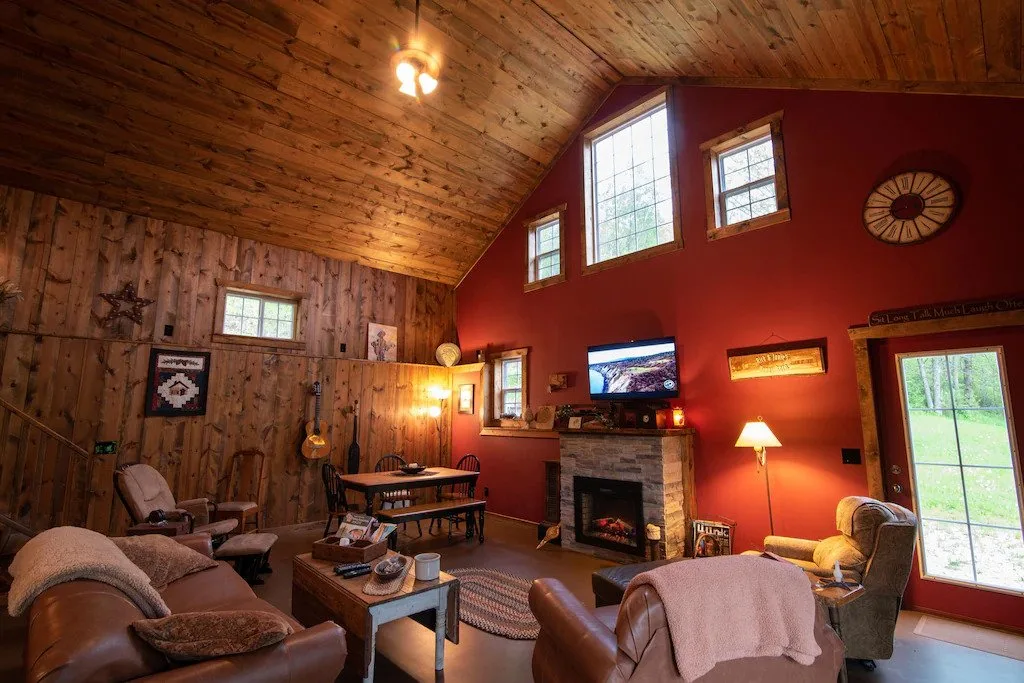 romantic glamping wisconsin, view of large living room with sofas, fireplace and tv