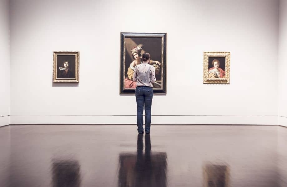things to do during one day in liege, woman standing in front of paintings in a museum