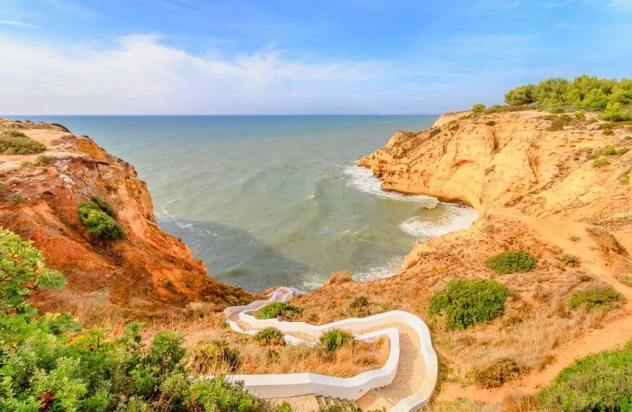 walking in albufeira, trail along the algarve coast of stairs leading to the water