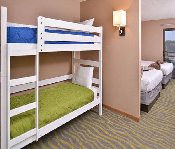 best Wisconsin Dells resorts for families, hotel room with bunk beds and two single beds