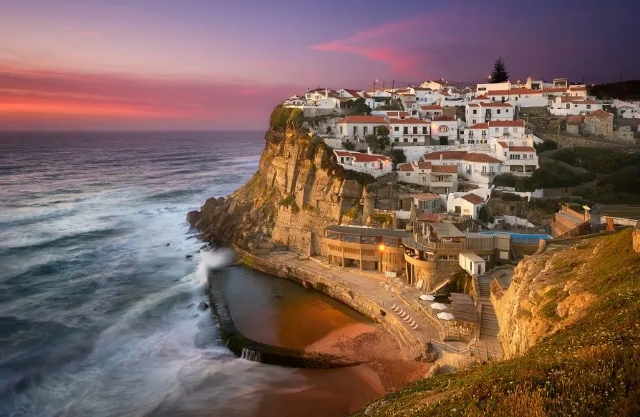 algarve hiking trails, view of coastal village Azenhas do Mar at sunset