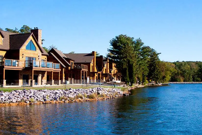 best romantic places to stay in Wisconsin Dells, exterior view of wooden cabins along lake