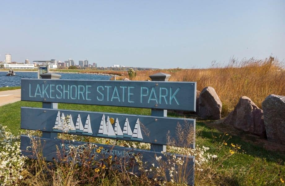 fun outdoor things to do in Milwaukee, sign for Lakeshore State Park with Milwaukee in background
