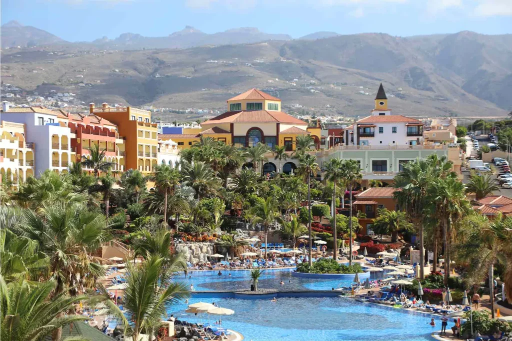 Best Tenerife spa hotels in Costa Adeje, resort area with large pool area surrounded by resort buildings