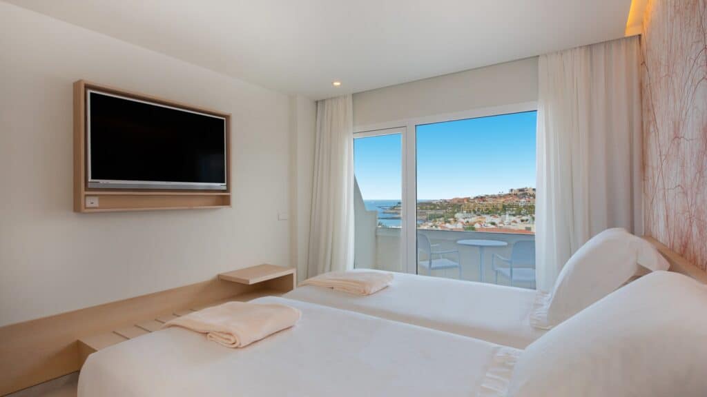 Enjoy these 5 star all inclusive adults only tenerife hotels, hotel room with balcony overlooking the city and ocean