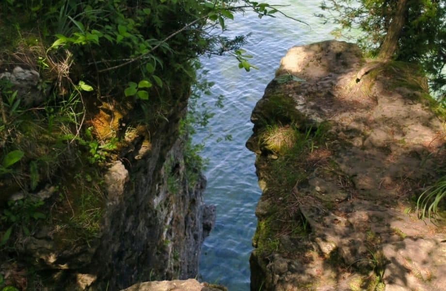 cliff drop into water between drops with weeds