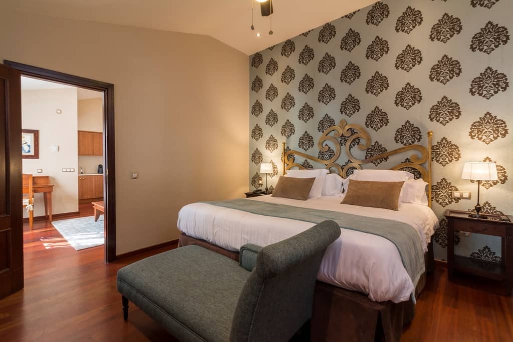 Luxury spa hotels in Tenerife, hotel room with bed and settee and a view through to adjoining kitchen area