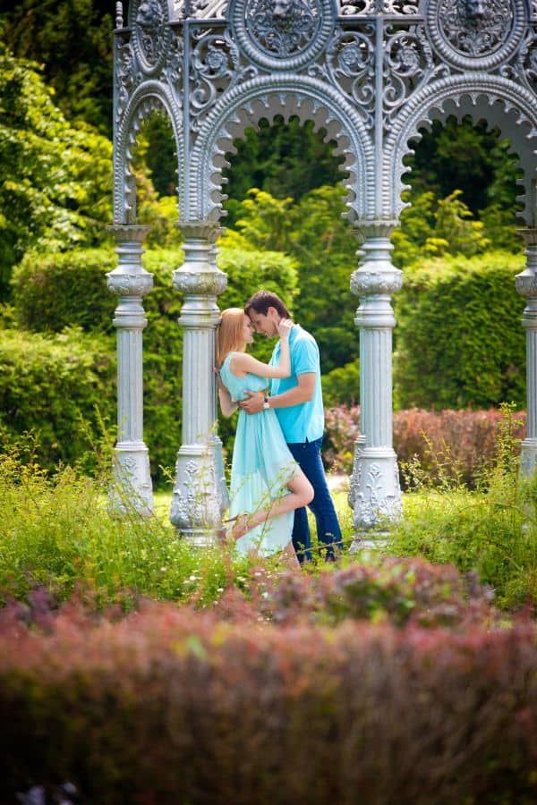 a couple posing romantically amidst a beautiful garden