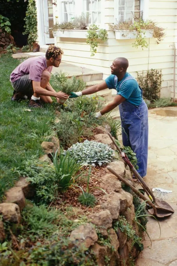 a gay couple enjoying time together as they help decorate their garden