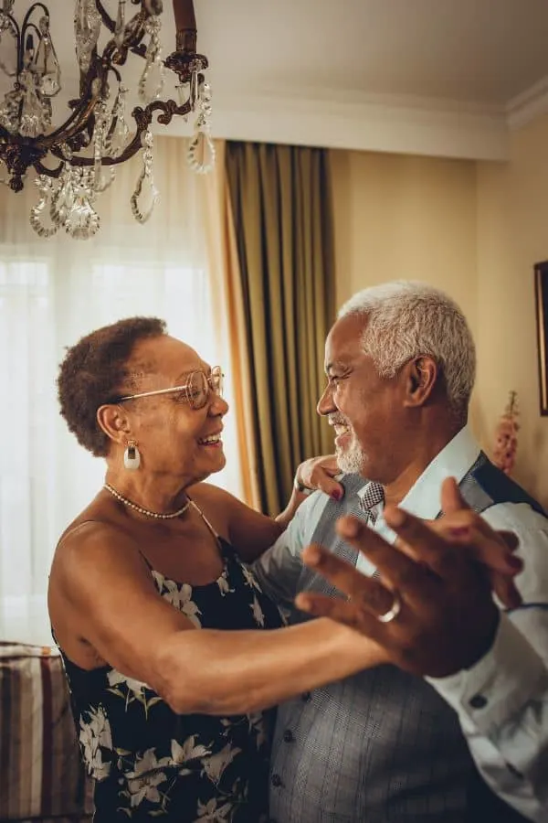 an older couple dancing together and looking happy and in love