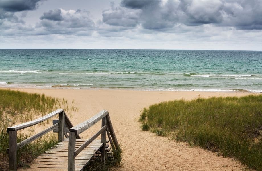 places to hike in Door County, wooden boardwalk leading to sandy beach on cloudy day