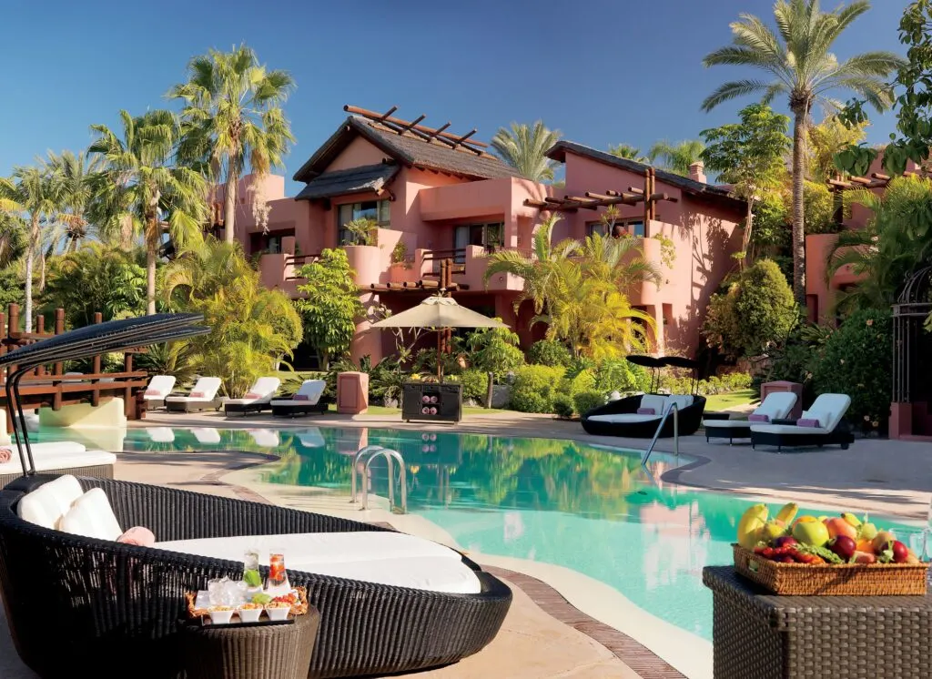 Best hotels for ​​wellness in Tenerife, exterior of hotel with pool surrounded by comfy deck chairs