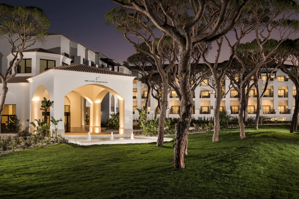 luxury hotels in Albufeira, exterior of the Pine Cliffs Garden lit up at night with trees outside