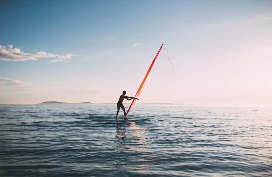 person windsurfing at dusk